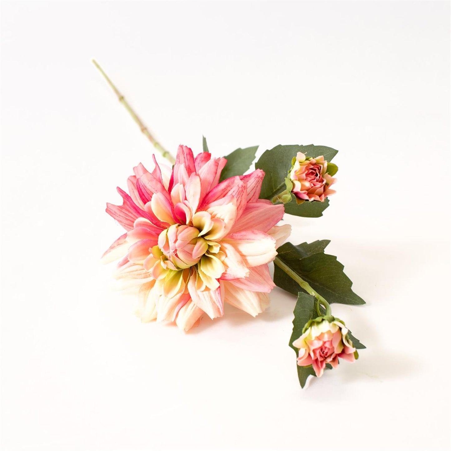 Artificial pink and green flower arrangement on a white background