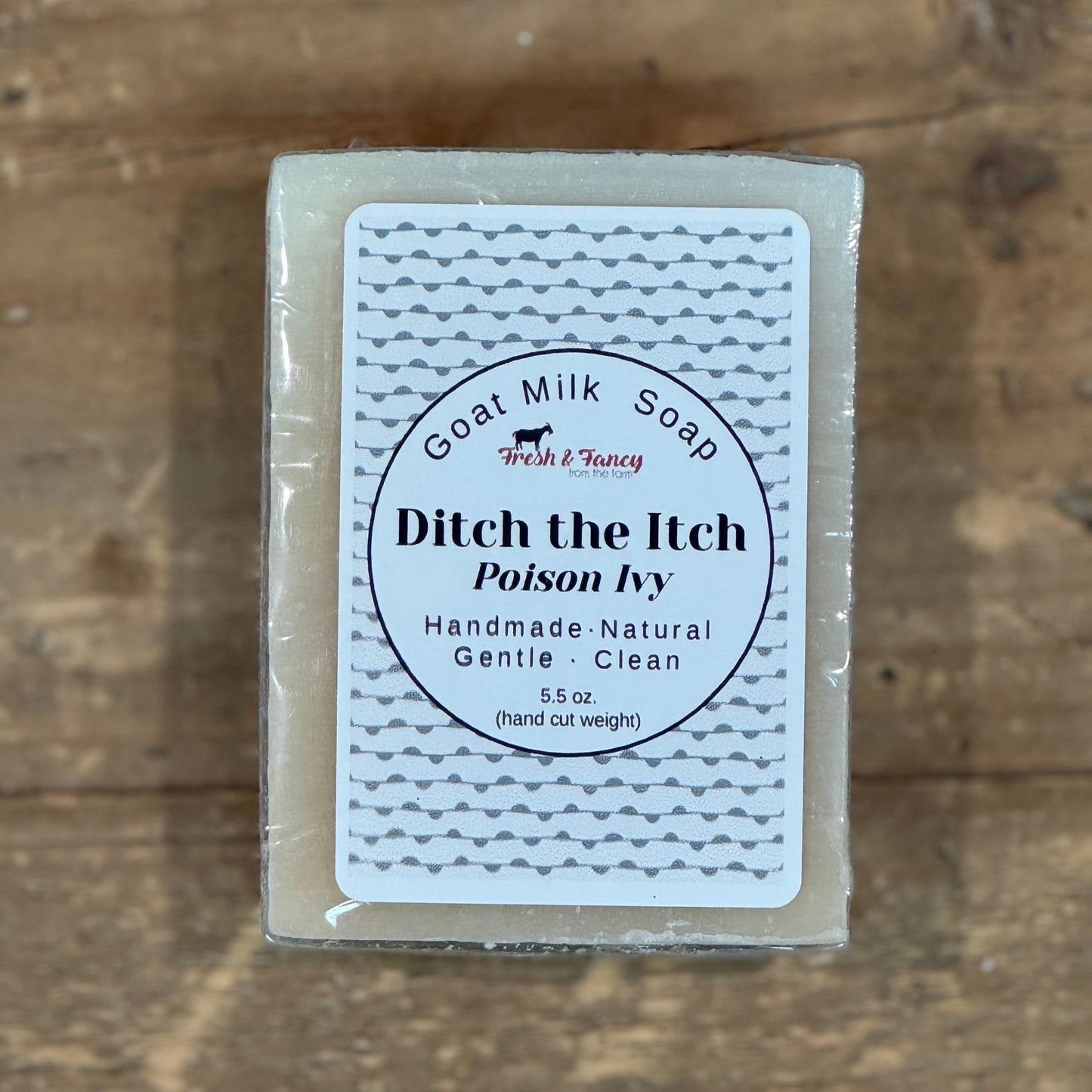 natural color soap with white label and grey squiggly lines throughout
