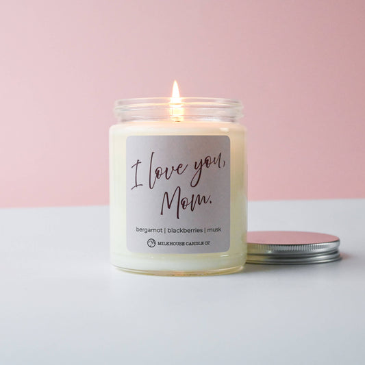 Candle with 'I Love You, Mom' label on a pink and white background