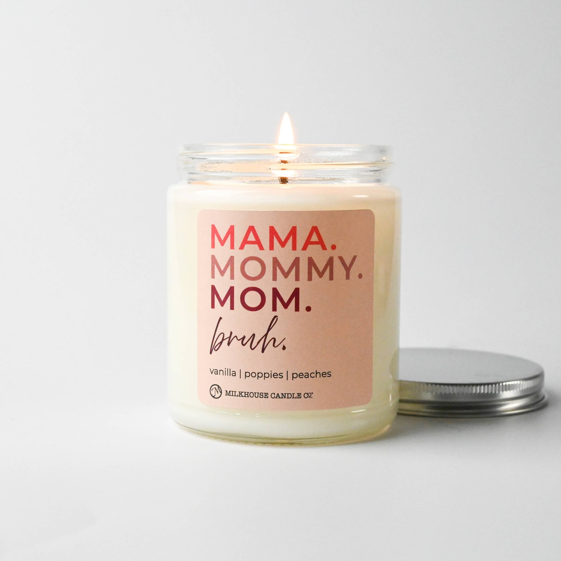 Candle with 'MAMA. MOMMY. MOM. bruh.' text on a white background
