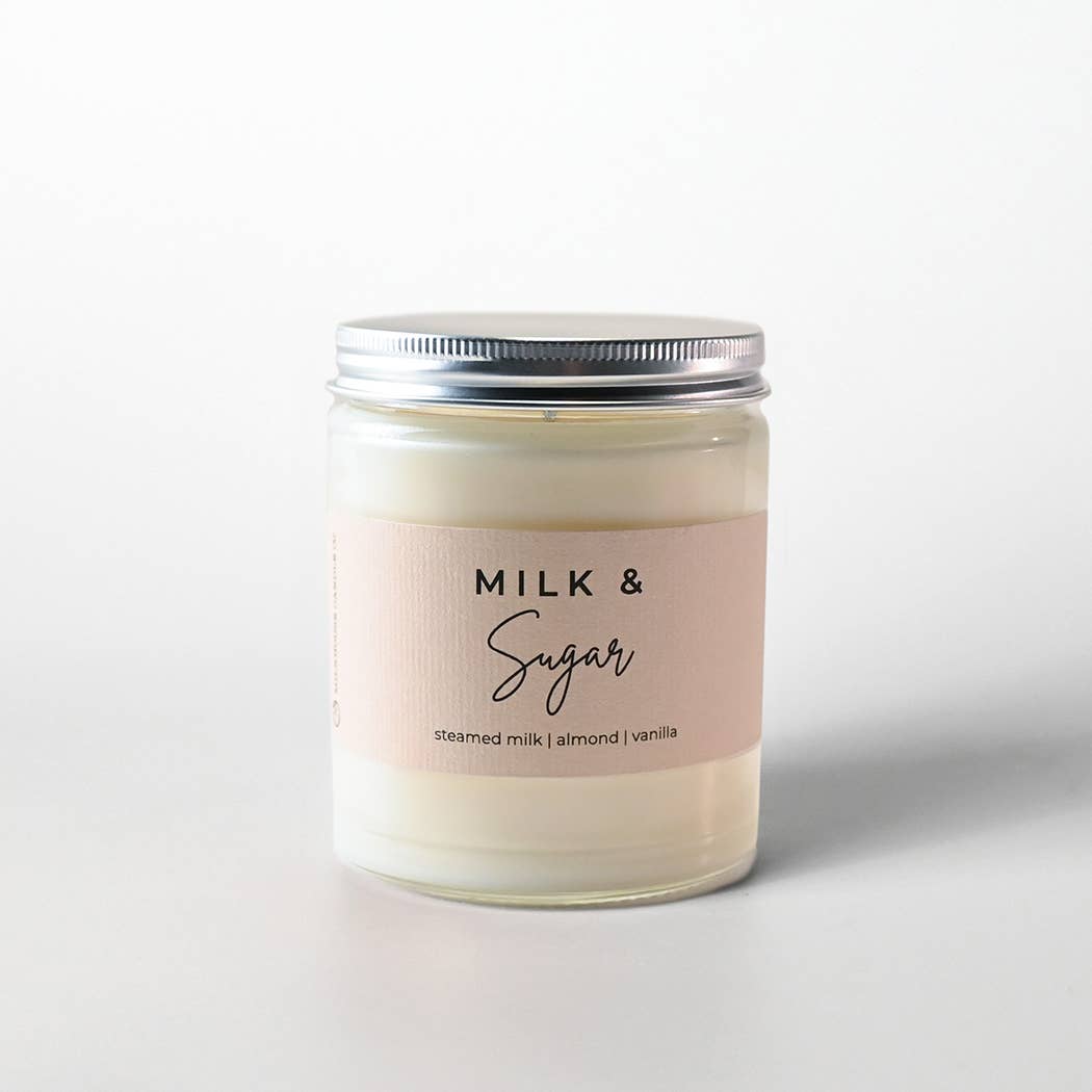 Candle jar labeled 'Milk & Sugar' on a white background