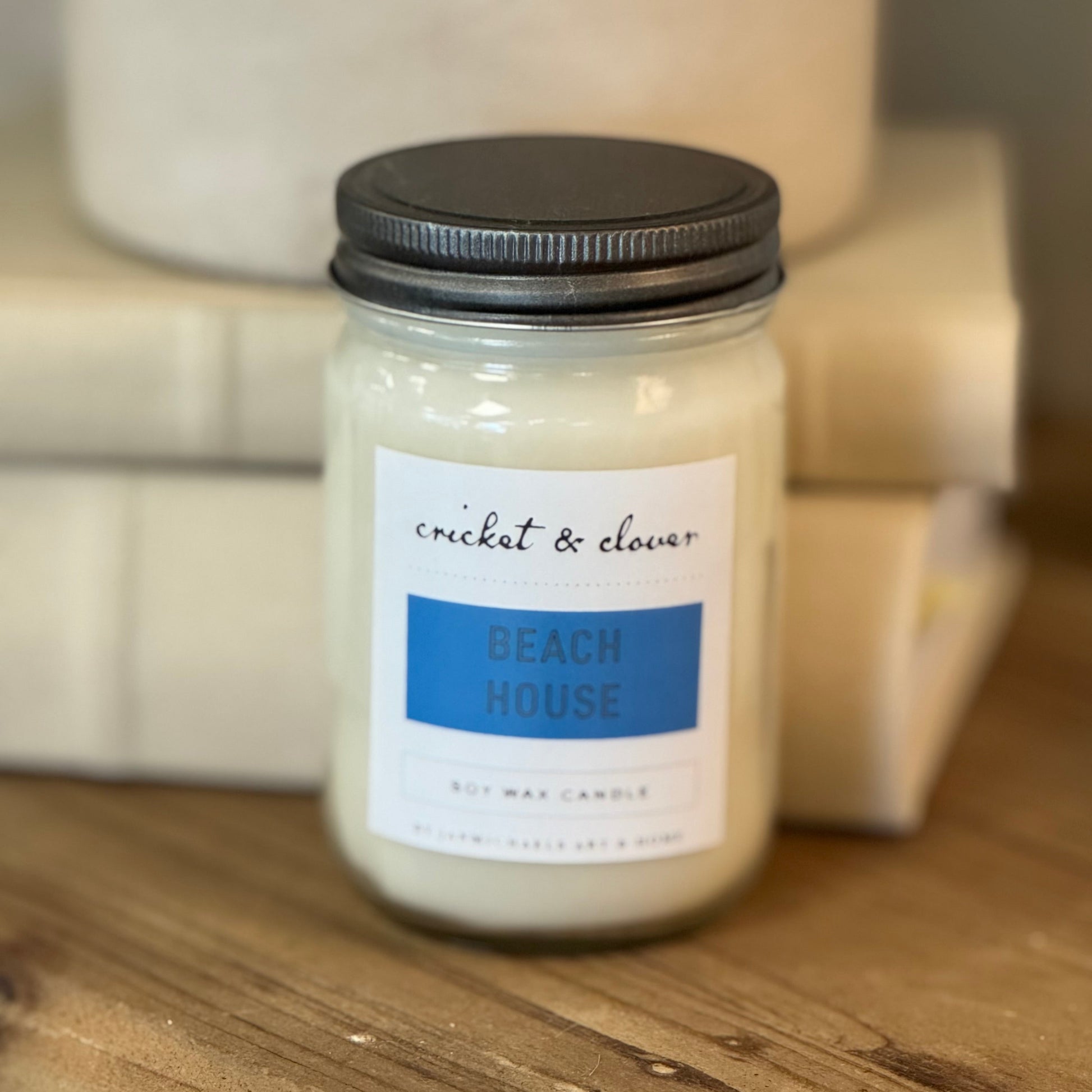 Mason jar with silver lid, white label with  blue.
