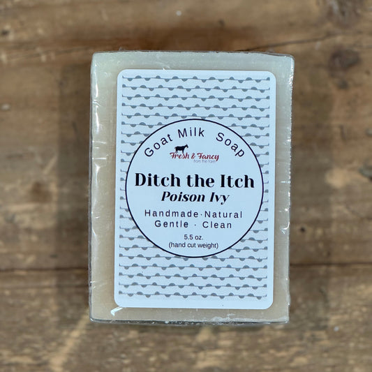 natural color soap with white label and grey squiggly lines throughout