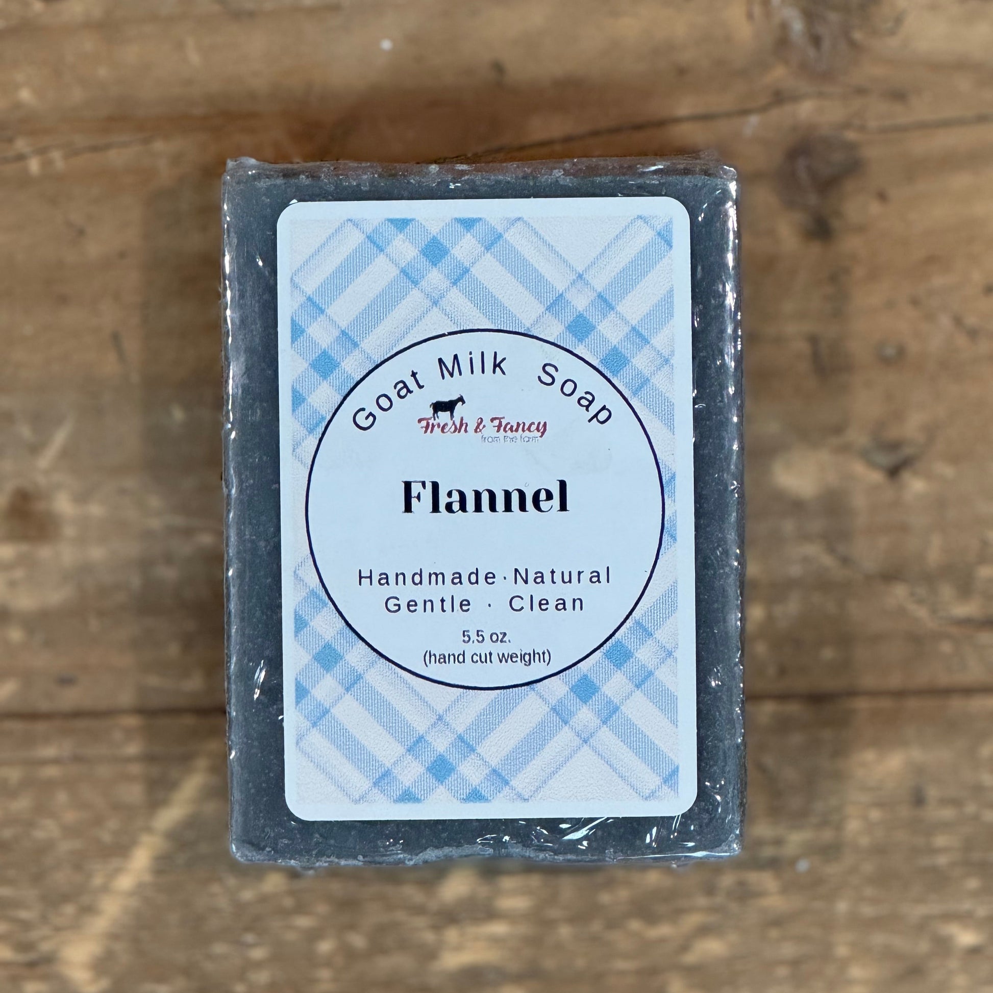 gray colored bar soap with a blue plaid label