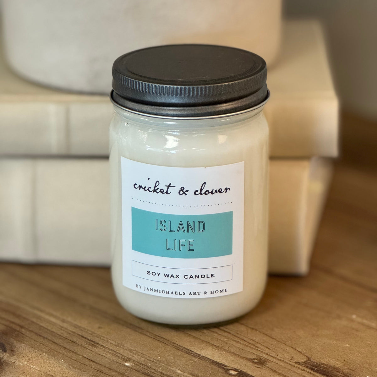 Mason jar with silver lid. White label with teal blue.