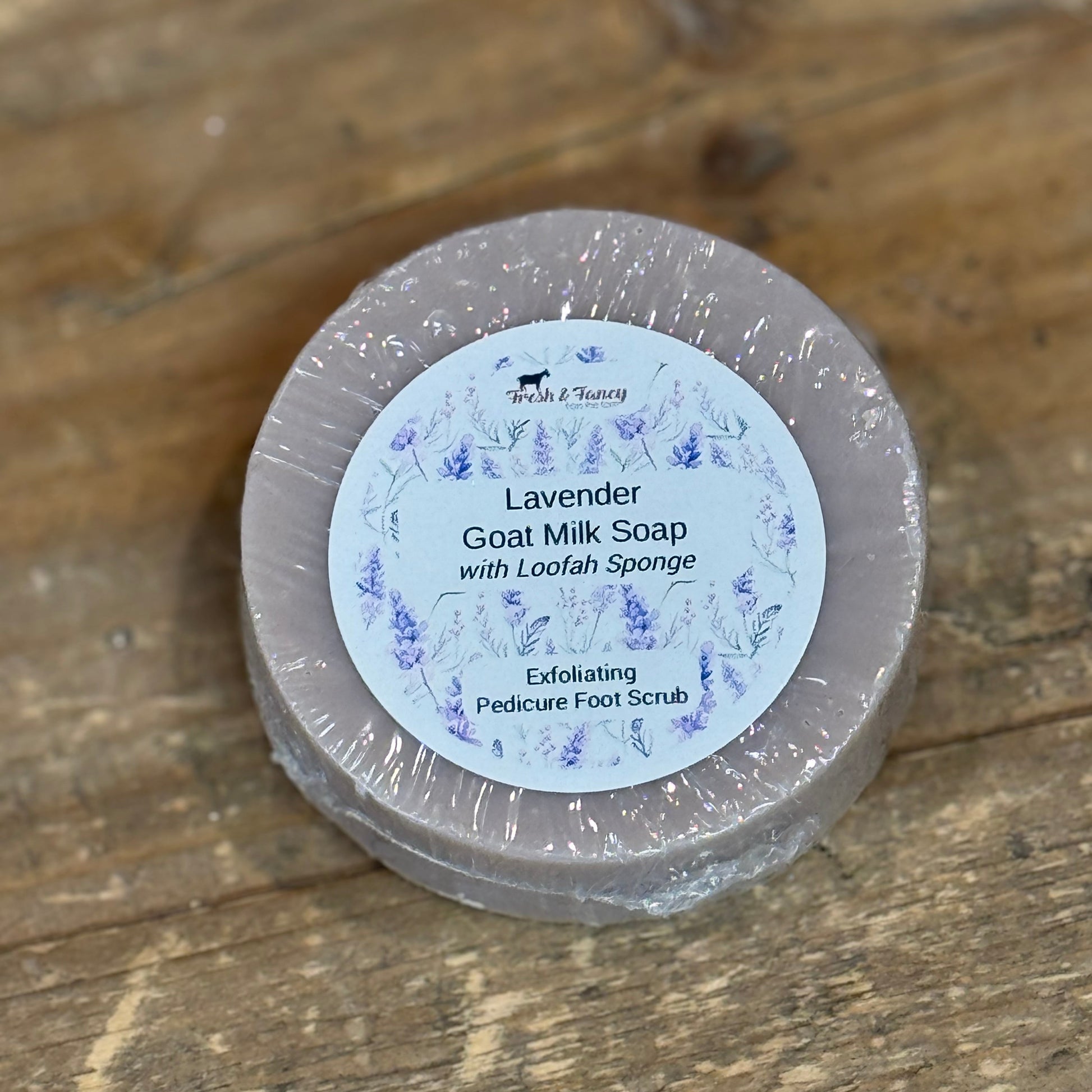 Round light purple soap with a lavender flower printed label