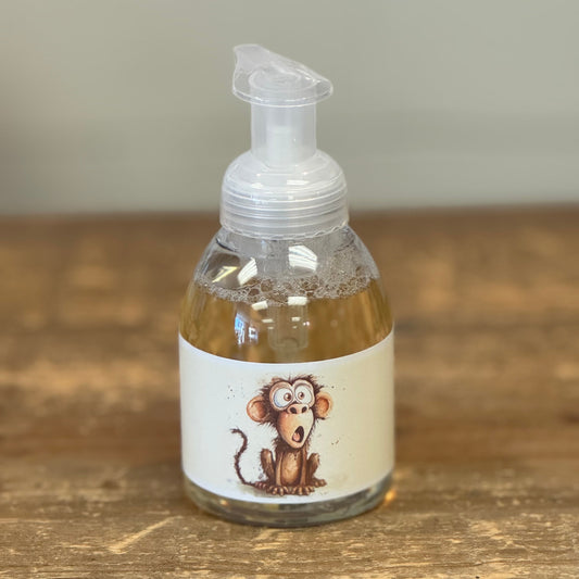 clear bottle with a hand pump and a monkey on the label